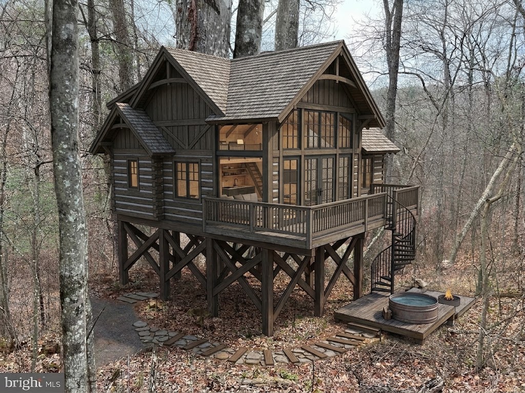 Architectural mockup of an elevated timber cabin among the trees at Crab Apple Road, with a wraparound deck, spiral stair, and soaking tub.